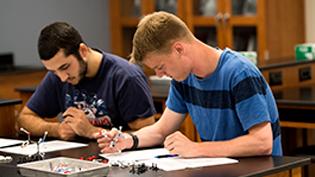 Two male students working in the biology lab