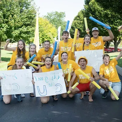 Students holding welcome signs